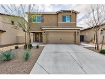 Two-story house with a two-car garage and landscaping at 521 Abrazar Ave, North Las Vegas, NV 89081