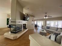 Spacious living room with a fireplace and large sectional sofa at 656 Hidden Cellar Ct, Las Vegas, NV 89183