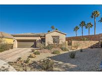 Single-story home with desert landscaping and a two-car garage at 685 Viale Machiavelli Ln, Henderson, NV 89011