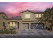 Two-story house with tan exterior, stone accents, and a two-car garage at 7528 Stray Horse Ave, Las Vegas, NV 89113