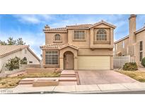 Two-story house with beige exterior, attached garage, and landscaping at 86 Myrtle Beach Dr, Henderson, NV 89074