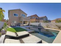 House with a backyard pool, patio, and artificial turf at 9570 Wenmarie Ct, Las Vegas, NV 89148