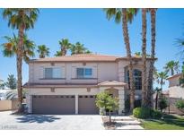 Two-story house with three-car garage and palm trees at 1015 Aspen Breeze Ave, Las Vegas, NV 89123