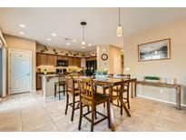 Open kitchen features a breakfast bar, tile flooring, recessed lighting and a dining area at 10260 Danskin Dr, Las Vegas, NV 89166