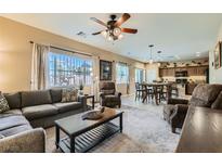 Spacious living room with comfortable seating and large windows at 10260 Danskin Dr, Las Vegas, NV 89166