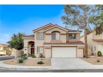 Two story house with tan exterior, brown roof, and a two car garage at 2153 Eaglecloud Dr, Henderson, NV 89074