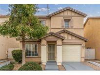 Two-story house with beige exterior, attached garage, and landscaping at 531 Dairy Creek Ave, Las Vegas, NV 89183