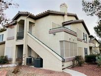 Multi-story condo building featuring private balconies, stucco siding, tile roofing, and well-maintained landscaping at 5710 E Tropicana Ave # 2122, Las Vegas, NV 89122