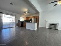 Open kitchen with island, stainless steel appliances, and wood cabinets at 6552 Boxwood Ln, Las Vegas, NV 89103