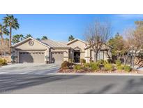 Single-story house with three-car garage, mature landscaping, and desert landscaping at 7220 Elderly Ave, Las Vegas, NV 89131