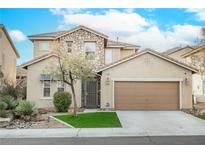 Two-story house with stone accents, a two-car garage, and a landscaped front yard at 189 Carneros Ave, Henderson, NV 89002