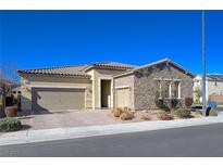 Charming single-story home featuring a three-car garage and a desert landscaped front yard at 2425 Amatrice St, Henderson, NV 89044