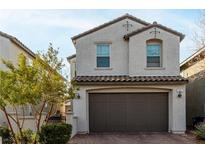 Two-story home with a two-car garage and well maintained landscaping in a neighborhood setting at 365 Andy Wheeler Dr, Henderson, NV 89011