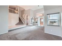 Spacious living room with high ceilings and a staircase leading to the second floor at 412 Lost Trail Dr, Henderson, NV 89014