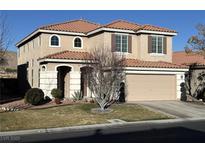 Charming two-story home featuring a tile roof, stucco siding, and a well-manicured front yard at 5859 Noble Stand St, Las Vegas, NV 89148