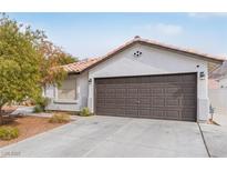 Single story home with attached garage and desert landscaping at 6168 Isthmus Cir, Las Vegas, NV 89110