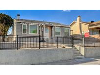 Charming single-story home with a well-kept front yard and wrought iron railing at 632 D, Boulder City, NV 89005