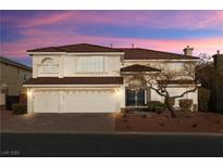 Two-story house with three-car garage, landscaping, and a tree in the front yard at 6442 Bright Nimbus Ave, Las Vegas, NV 89139