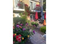 Charming patio with brick pavers, colorful flowers, and seating area at 738 Tam O Shanter, Las Vegas, NV 89109