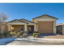 Single-story home with a two-car garage and landscaped front yard at 757 Goodman Cove St, Henderson, NV 89011