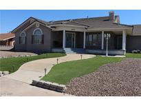 Beautiful ranch-style home with landscaped lawn and inviting front porch at 830 Park Ln, Henderson, NV 89015