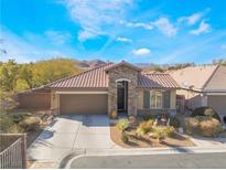 Charming single-story home featuring a well-manicured front yard and a two-car garage at 10397 Station Creek Cir, Las Vegas, NV 89178