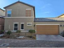 Two-story house with attached garage and landscaped front yard at 1050 Spotted Saddle St, Henderson, NV 89015