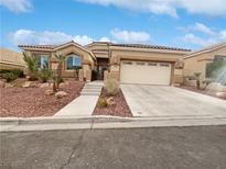 Single-story house with desert landscaping and two-car garage at 10809 Windrose Point Ave, Las Vegas, NV 89144
