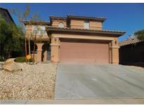 Two story house with attached garage and desert landscaping at 11173 Hickory Glen St, Las Vegas, NV 89179