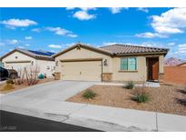 Charming single-story home featuring a two-car garage, desert landscaping, and a cozy front porch at 1876 Neoga St, Las Vegas, NV 89115