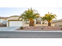 Single-story house with desert landscaping and two palm trees at 2771 Fort Myer Ave, Henderson, NV 89052