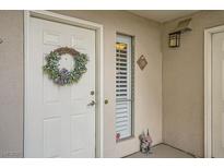 Inviting condo entry with wreath and white door at 2855 Geary Pl # 3205, Las Vegas, NV 89109