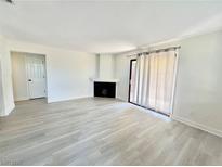 Bright living room with fireplace and sliding glass door to patio at 601 Cabrillo Cir # 1293, Henderson, NV 89015