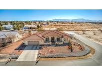 Single-story home with desert landscaping, driveway, and mountain views at 741 Antelope Ave, Pahrump, NV 89060