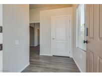 Bright entryway with laminate flooring, neutral walls, and an interior door at 8805 Jeffreys St # 1115, Las Vegas, NV 89123