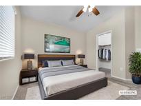 Bright bedroom featuring a walk-in closet, plush rug, and neutral decor at 9323 Leaping Deer Pl # 102, Las Vegas, NV 89178