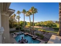 Luxury home featuring a private pool with golf course views and towering palm trees, perfect for outdoor relaxation at 9408 Players Canyon Ct, Las Vegas, NV 89144
