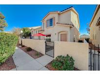 Two-story house with a red umbrella and small patio at 9567 Belle Reserve St, Las Vegas, NV 89123