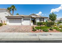 One-story house with three-car garage and landscaped front yard at 11268 Lavandou Dr, Las Vegas, NV 89141