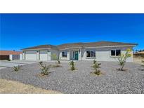 Charming single-story home with a three-car garage and drought tolerant landscaping at 2280 S Pampa Ave, Pahrump, NV 89048