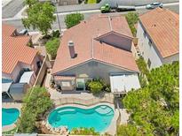 Aerial view of a private backyard featuring a sparkling pool and well-maintained landscaping at 3324 Canyon Lake Dr, Las Vegas, NV 89117