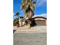 House exterior showcasing a two-car garage and desert landscaping at 3710 Royal Fern Cir, Las Vegas, NV 89115