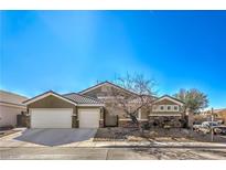 Single-story house with a two-car garage and desert landscaping at 5635 Exotic Rosette Ave, Las Vegas, NV 89139