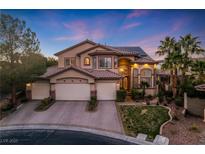 Beautiful two-story home with a three-car garage, desert landscaping, and solar panels at 5734 San Florentine Ave, Las Vegas, NV 89141