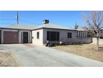 Charming single-story home with a front yard, driveway, and a one car garage at 612 Essex East Dr, Las Vegas, NV 89107