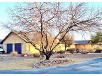 Ranch style home with attached garage and mature trees at 7415 Constantinople Ave, Las Vegas, NV 89129