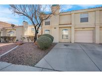 Two-story stucco home with attached garage and landscaped front yard at 7933 Delbonita Ave, Las Vegas, NV 89147