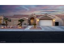 Single-story home with a two-car garage and landscaped front yard at 8044 Edward Baher Ave, Las Vegas, NV 89149