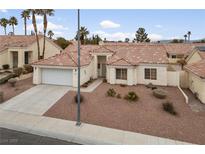 Single-story home with a two-car garage and desert landscaping at 8212 Bolingbrook Ave, Las Vegas, NV 89149