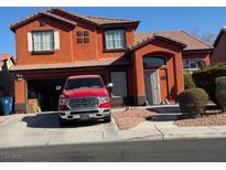 Two-story house with a red exterior and a red truck parked in the driveway at 1754 Green Apple Way, Las Vegas, NV 89142